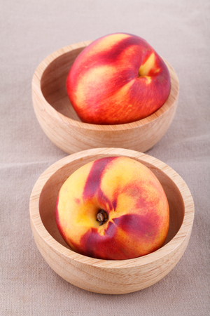 nectarines in bowl on wood tableの写真素材