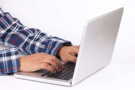 Hands typing on keyboard of laptop on white backgroundの写真素材