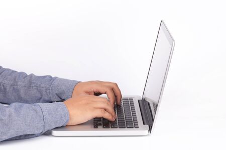 Hands typing on keyboard of laptop on white background