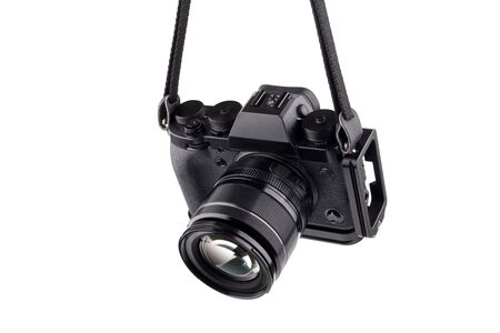 Mirrorless photo camera on white background