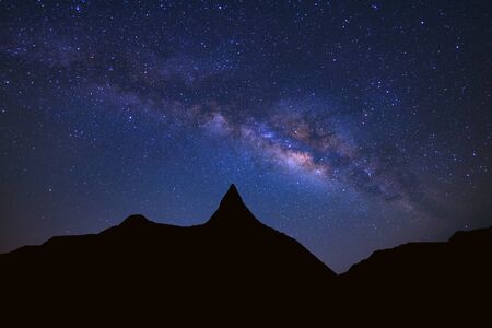 Starry night sky with high moutain and milky way galaxy with stars and space dust in the universeの写真素材