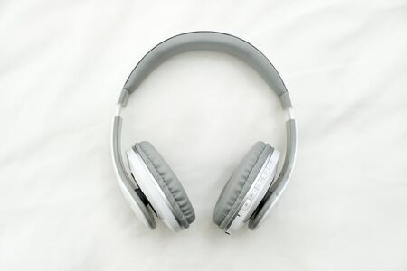 headphones on white fabric backgroundの写真素材
