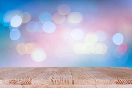 Wood table top on bokeh orange background - can be used for montage or display your productsの写真素材