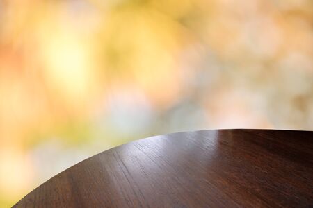 Wood table top on bokeh orange background - can be used for montage or display your productsの写真素材