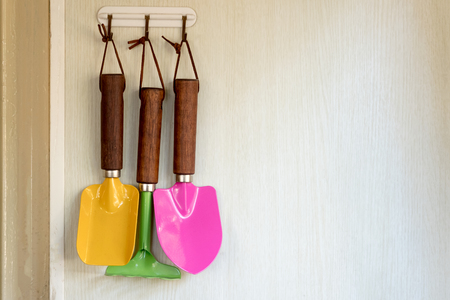 Gardener colored tools hold on wallの写真素材