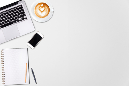 Top view laptop computer or notebook,mobile phone and cup of latte art coffee on wooden table. Business template mock up for adding your text.
の写真素材
