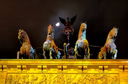 Chariot on top of Brandenburg Gate with moon and hazeの写真素材