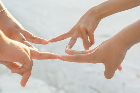 hands Sporting local children on playgroundの写真素材