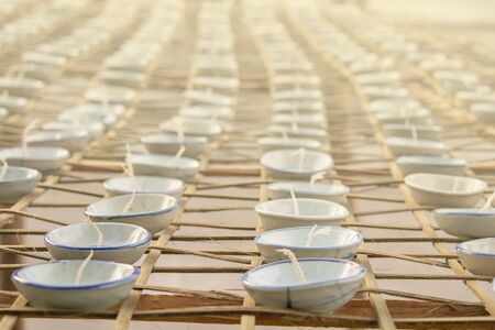 Small cups lined up on bamboo.