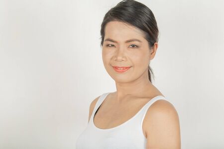 Woman and sweet smile. Thai style wearing a white shirt Modern fashion and good health for women