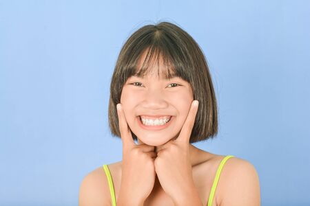Asian Cute teen on blue backgroundの写真素材
