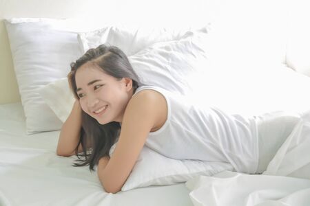 healthy  woman white on bed in a roomの写真素材