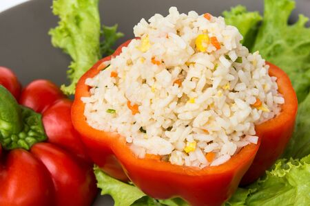 Stuffed peppers with rice and vegetables on black Plateの写真素材
