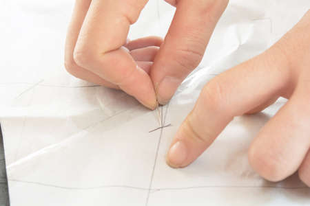 Hand and sewing clothes background.
