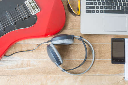 Headphones and notebook computers on wood