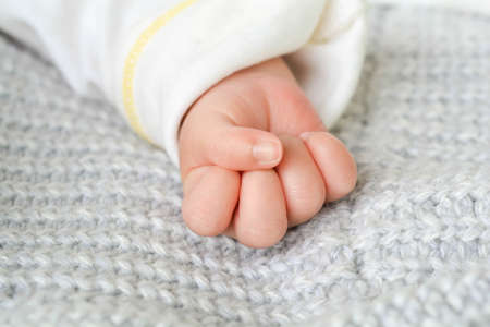 Cute children's hands On a newborn baby mattress on the handの写真素材