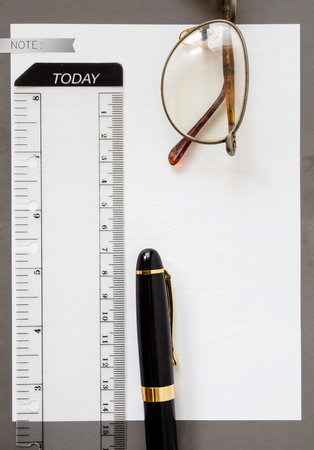 note book paper with Fountain penの写真素材