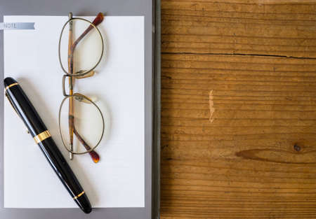 note book paper with Fountain penの写真素材