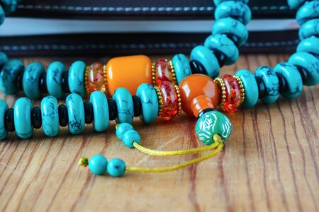 ethnic beads of various colors on a wooden backgroundの写真素材