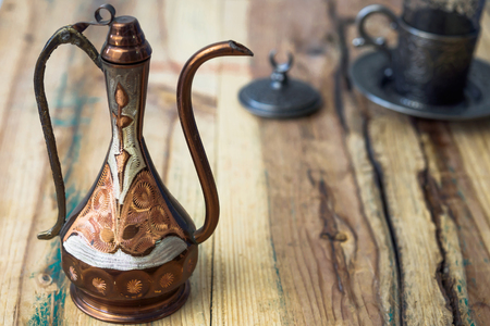 Turkish teapot with arabic decoration with metal cup and dishの写真素材