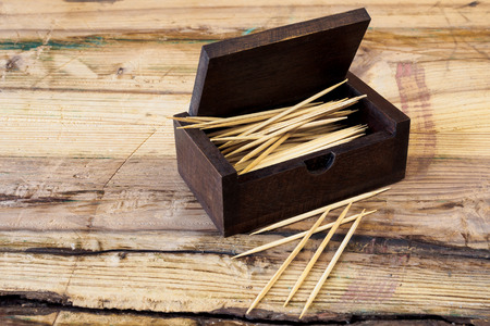 Box of toothpicks on wood tableの写真素材