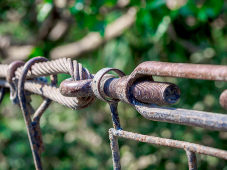 Rusty sling hook  and knots close, bolts used to mount the bridge rail.の写真素材