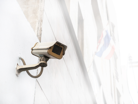 Old and dirty cctv camera installed outside the buildingの写真素材