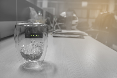 Ice in glasses on working table in vintage toneの写真素材