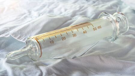 50 Ml. Glass syringe for feeding on white fabricの写真素材