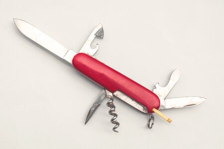 Red multipurpose knife on white background