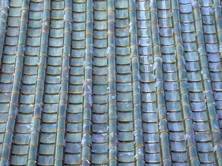 green orange glazed terracotta roof tiles of a Chinese templeの写真素材