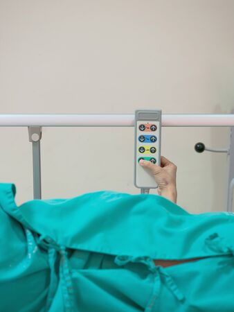 Hospital bed remote control in the patient's hand