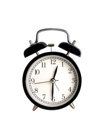 Vintage black alarm clock on a white background