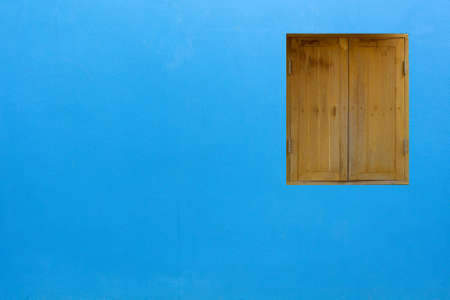 Vintage wood window on lue cement wallの写真素材