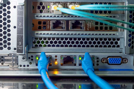 Lan and fiber optic cables are plugged into the back panal of the server.