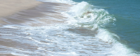 Sea waves blow on the sandy beach. for background