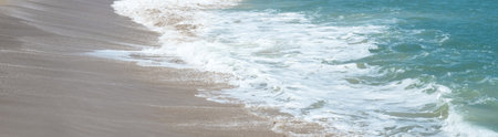 Sea waves blow on the sandy beach. for background