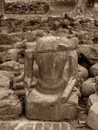 The broken remains of an ancient 20th-century Buddha statue in vintage toneの写真素材