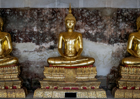 Beautiful golden Buddha statue in a temple in Thailandの写真素材