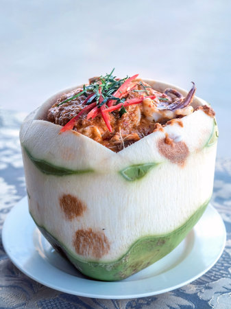 Close up of Steamed curry seafood in young coconut,selective focusの写真素材