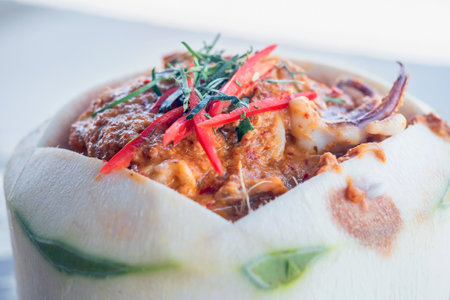 Close up of Steamed curry seafood in young coconut,selective focusの写真素材