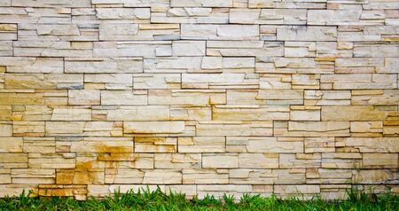 Stone wall with grass under lining