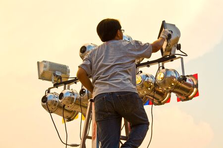 Man fixing spotlightの写真素材