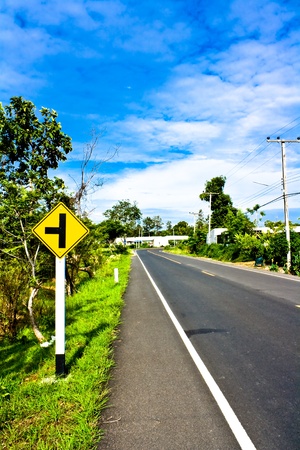 Empty road with a traffic sign  in countryside of Thailandの写真素材