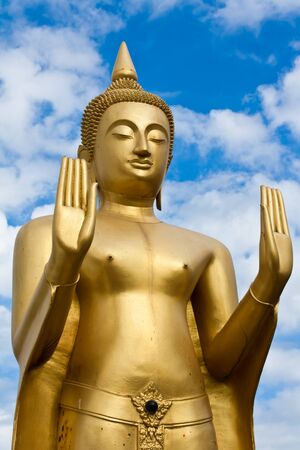 Golden standing Buddha statue inside a temple in Ubonratchathani, Thailand の写真素材