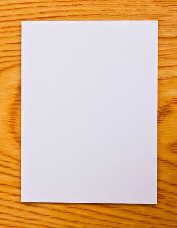 White paper on wood table の写真素材
