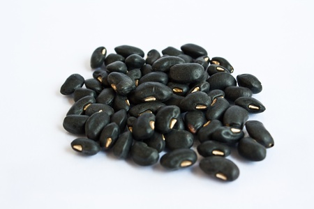 A small handful of black beans - preto. Beans isolated on a white background. Close-up. の写真素材