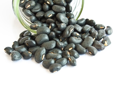 Black beans in a bottle on white background の写真素材