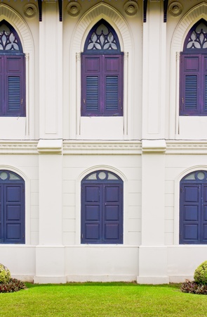 White wall with  gothic  blue wood windowsの写真素材