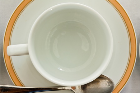 Empty cup and saucer with teaspoon,top viewの写真素材